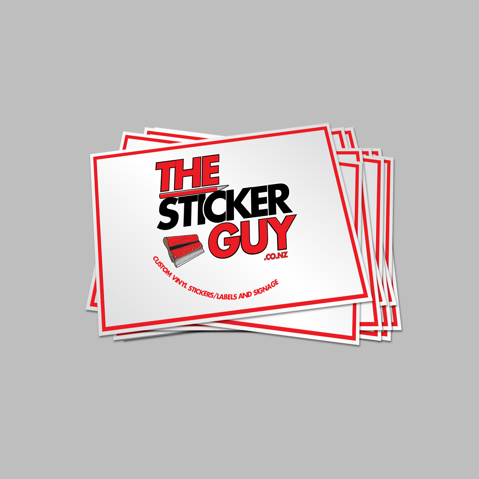 Stack of 'The Sticker Guy' branded stickers on a gray background
