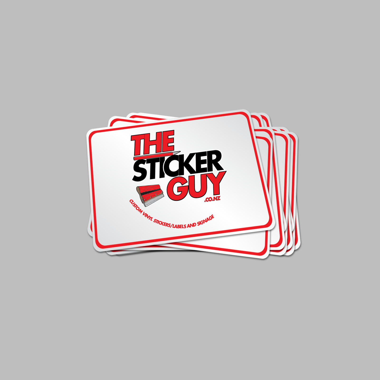 Stack of 'The Sticker Guy' branded stickers on a gray background