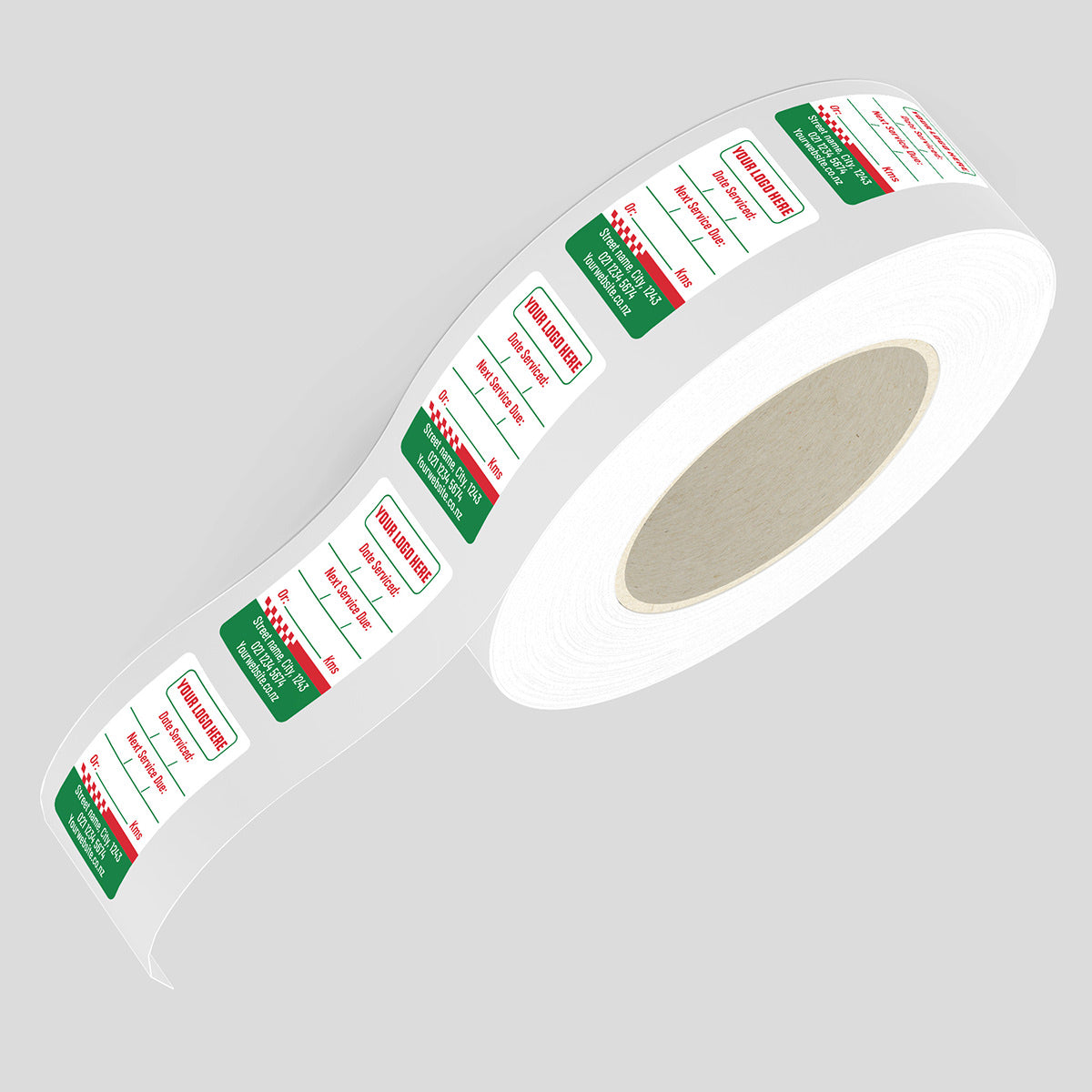Roll of labels with green and red text on a gray background