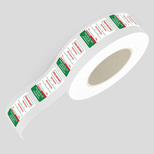 Roll of labels with green and red text on a gray background
